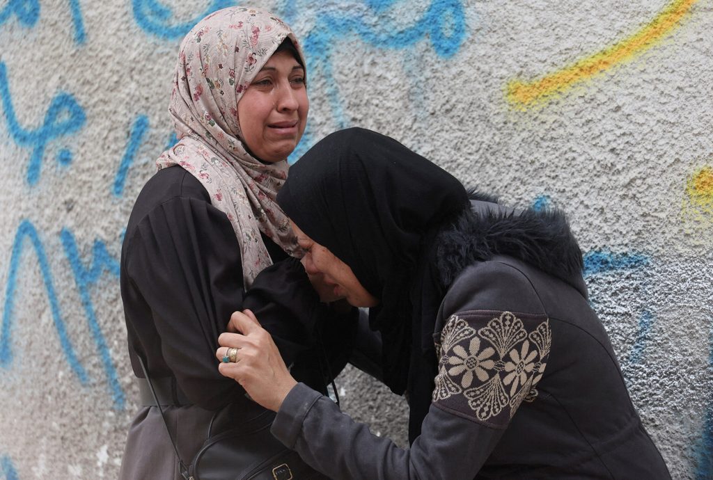 Mourners react during the funeral of Palestinians who, according to medics, were killed by Israeli strikes Thursday at Al-Shifa Hospital, in Gaza