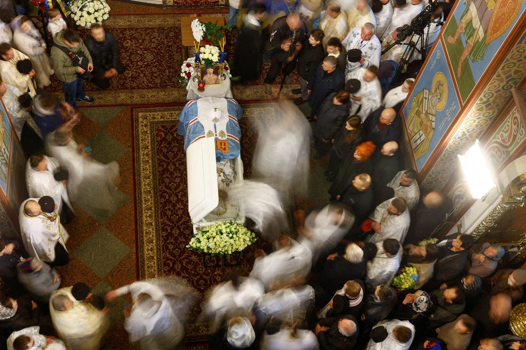 Clergymen and believers attend a funeral service for the late Patriarch Filaret inside the Saint Michael's Cathedral in Kyiv