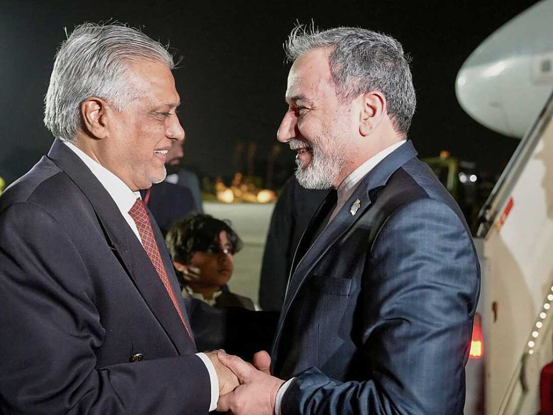 This handout photo released by the Iranian foreign ministry shows Pakistan's Foreign Minister Ishaq Dar (L) greeting his Iranian counterpart Abbas Araghchi upon his arrival in Islamabad on April 24, 2026.