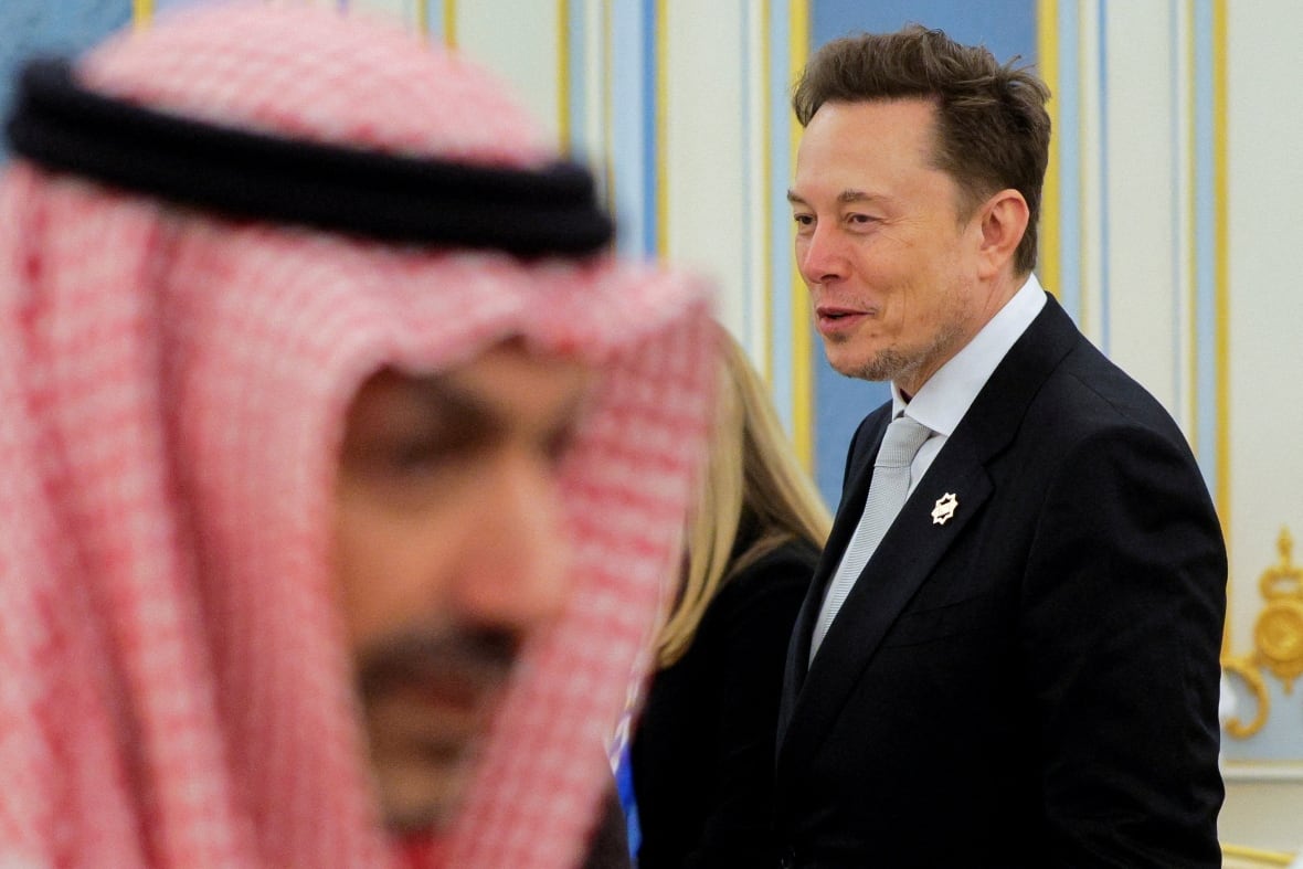 Musk seen smiling in front of a Saudi official