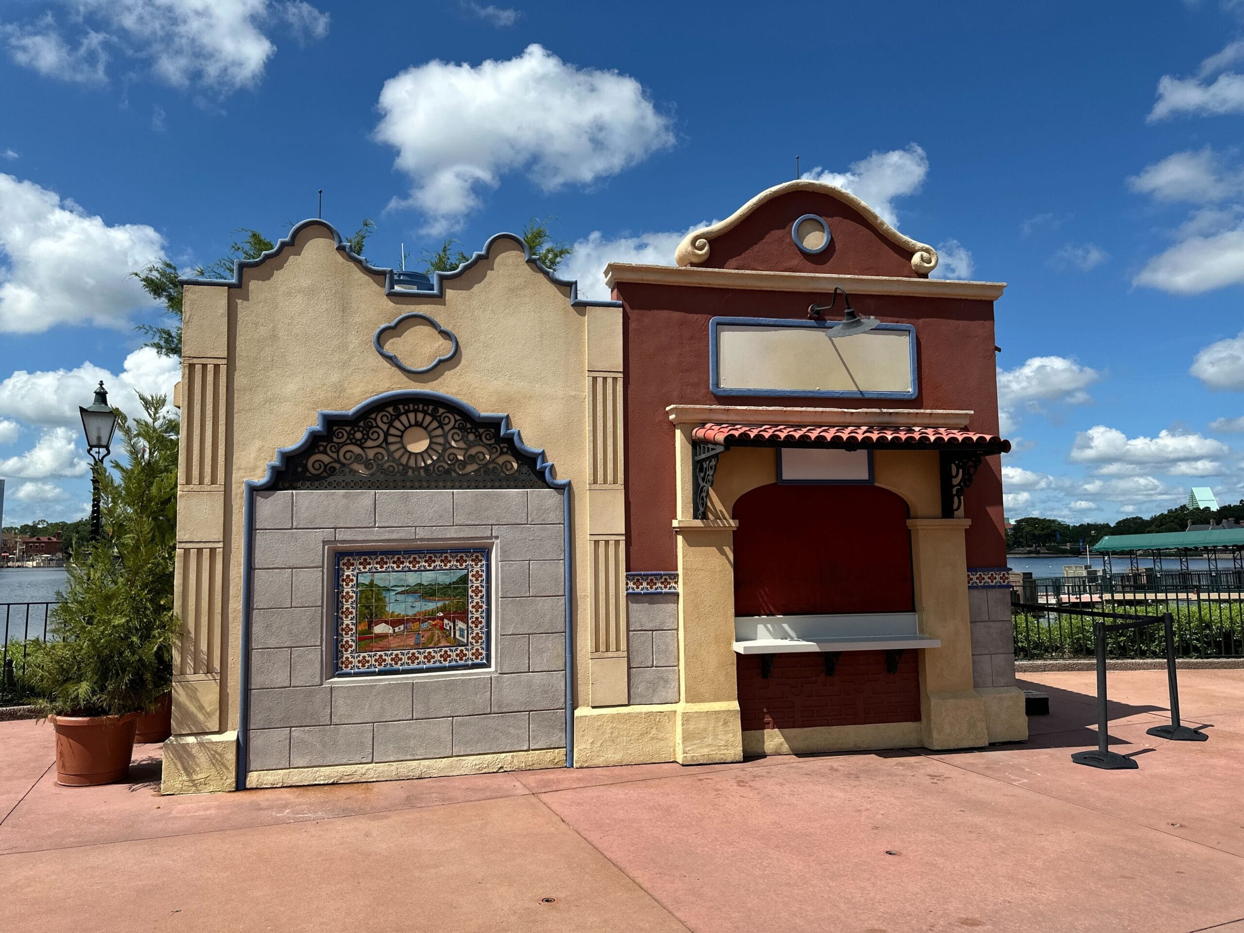 Two colorful, empty food booths with tile accents signal EPCOT International Food & Wine Festival 2025 preparation.